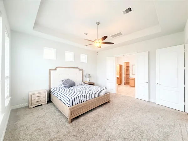a bedroom with a bed rug and ceiling fan