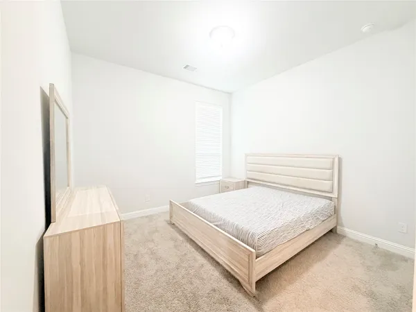 a bedroom with a bed and a cabinets