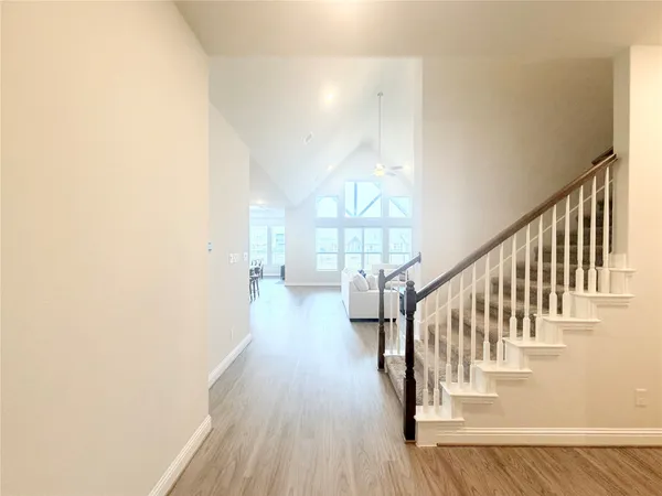 a view of entryway and hall with wooden floor