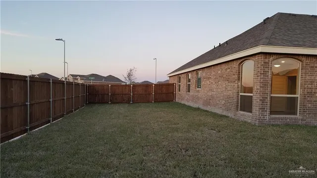 a view of a house with a backyard