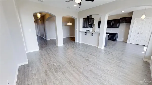 a view of a kitchen with wooden floor and a refrigerator