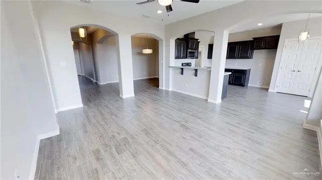 a view of a kitchen with wooden floor and a refrigerator
