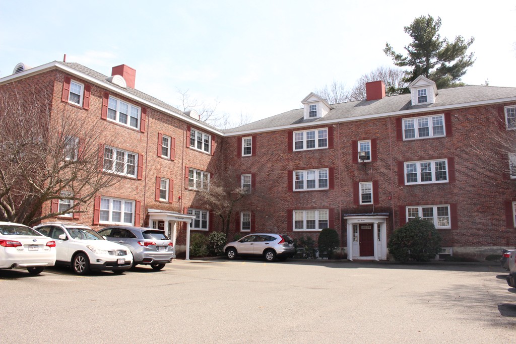 a view of a street that has couple of cars parked on the road