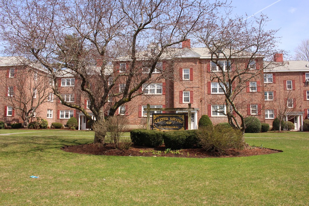 112 Maple Street, Unit 6 Malden, MA 02148 - Photo 2 of 6 a front view of a house with a garden and trees