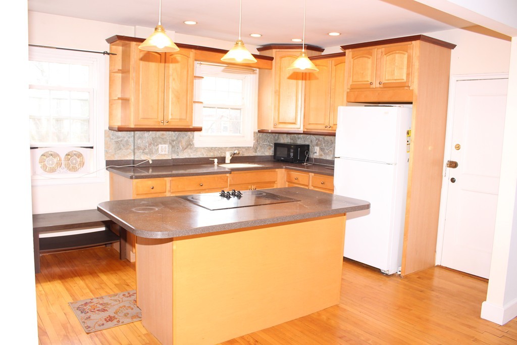 112 Maple Street, Unit 6 Malden, MA 02148 - Photo 3 of 6 a kitchen with a sink a stove and a refrigerator