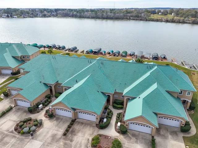 an aerial view of a swimming pool with lawn chairs