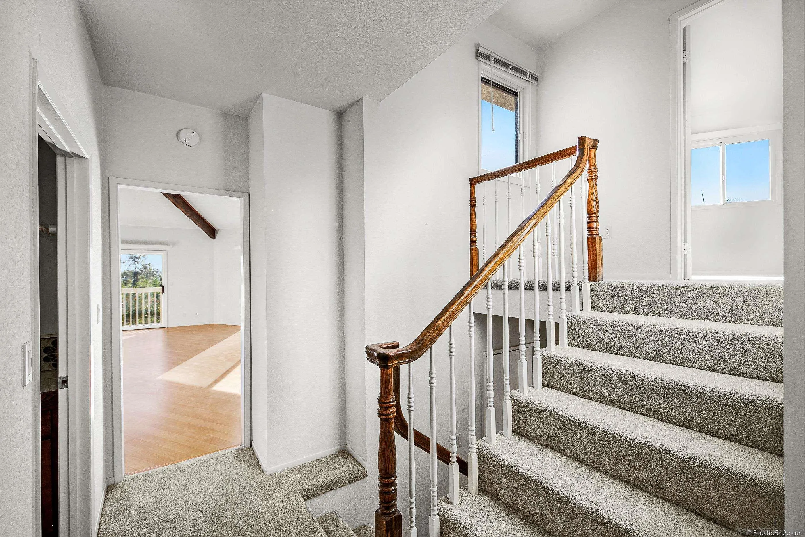 1112 Oceanic Drive Encinitas, CA 92024 - Photo 17 of 32 a view of staircase with wooden floor and a rug