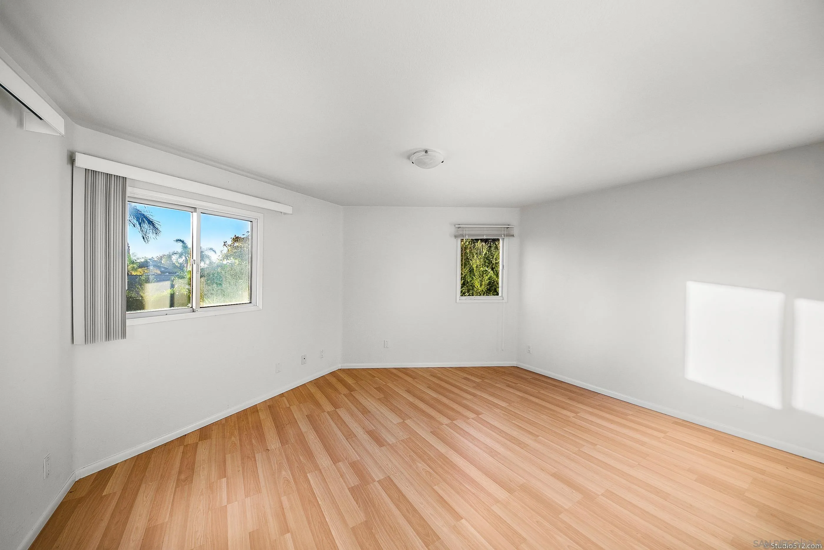 1112 Oceanic Drive Encinitas, CA 92024 - Photo 20 of 32 a view of empty room with wooden floor and fan