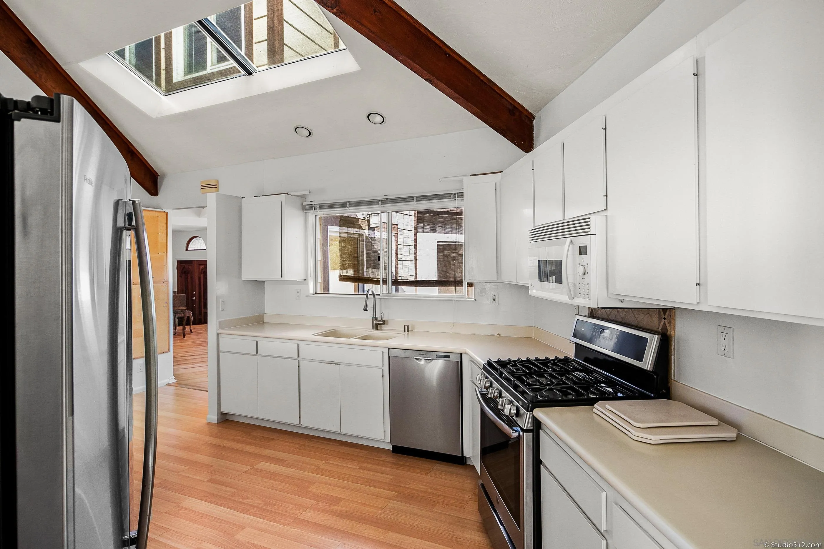 1112 Oceanic Drive Encinitas, CA 92024 - Photo 8 of 32 a kitchen with stainless steel appliances a sink a stove a refrigerator and cabinets