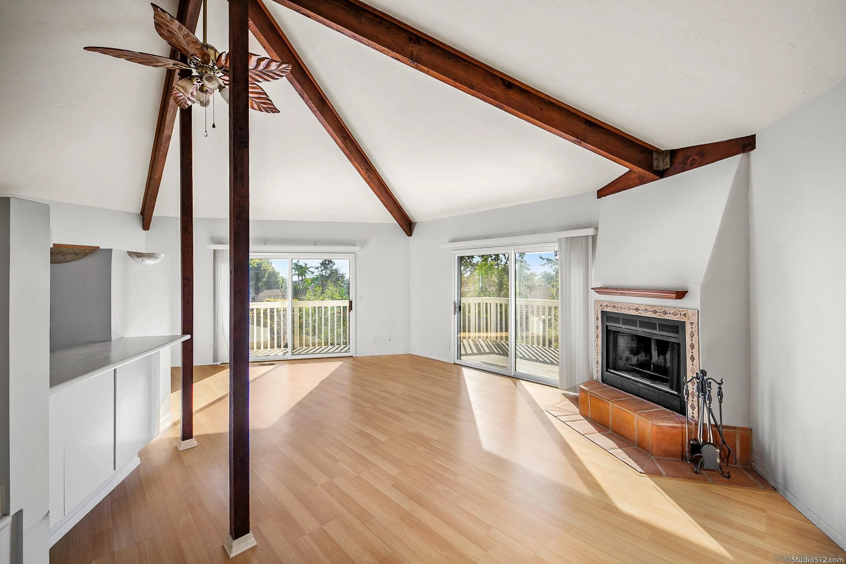 1112 Oceanic Drive Encinitas, CA 92024 - Photo 10 of 32 a view of an empty room with wooden floor fireplace and a window