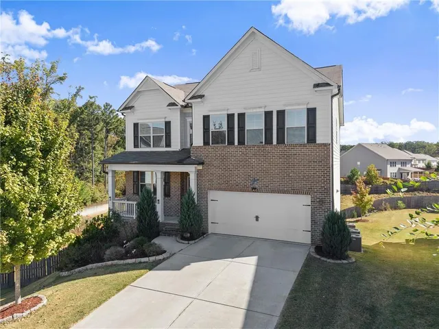 a front view of a house with a yard and garage