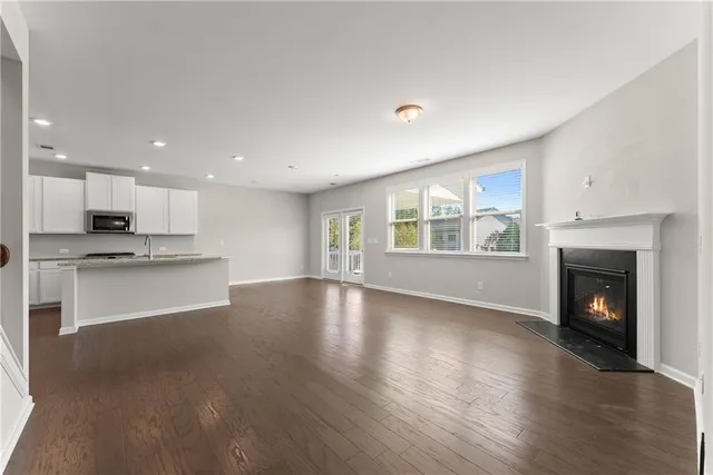 a view of an empty room with window and fire place