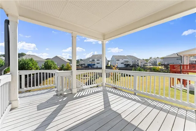 a view of balcony with wooden floor and fence