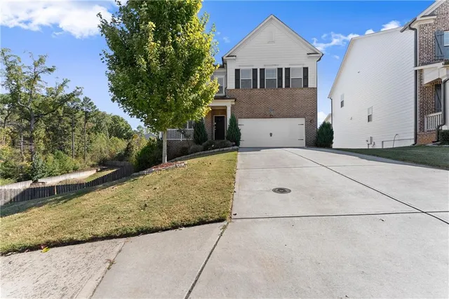a front view of a house with a yard