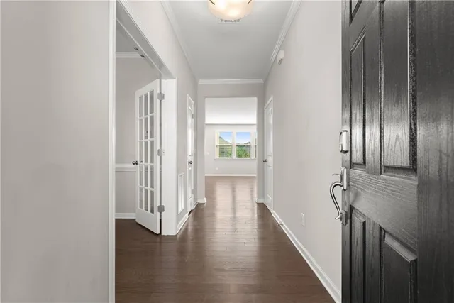 a view of a hallway with wooden floor