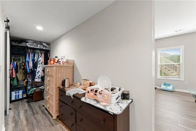 a living room with furniture gym equipment and a window