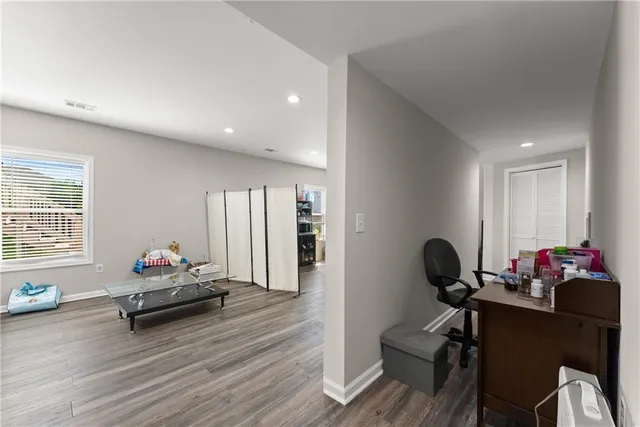 a view of a workspace with furniture and wooden floor