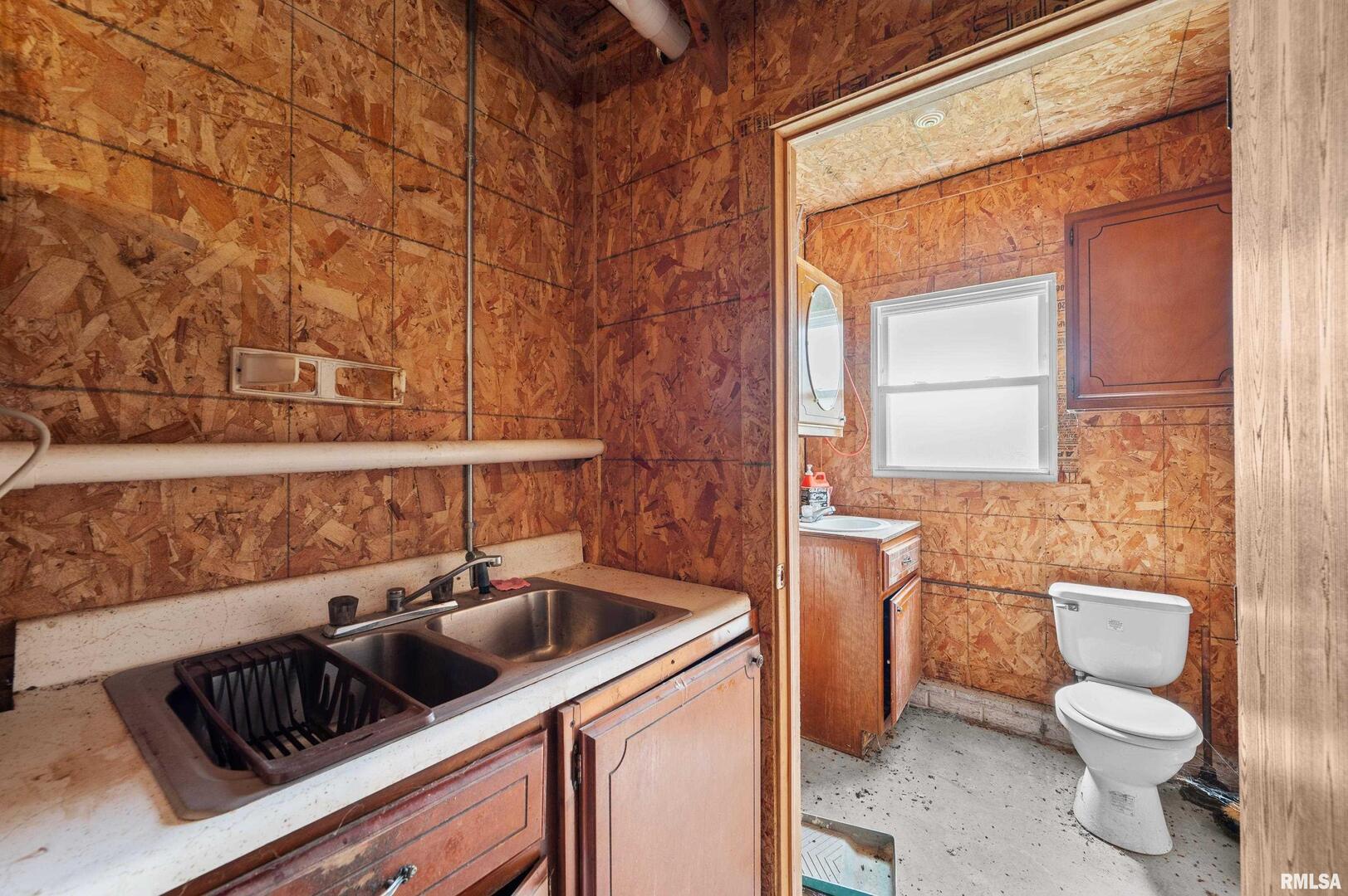 242 South State Avenue Hampton, IL 61256 - Photo 14 of 18 a bathroom with a toilet sink and mirror