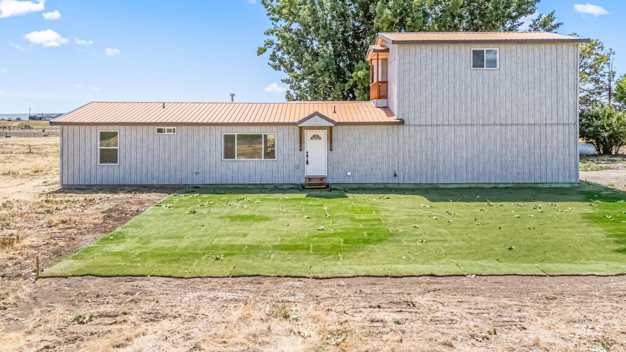 1117 Olds Ferry Road Weiser, ID 83672 - Photo 2 of 36 View of front of home with a metal roof and a front lawn