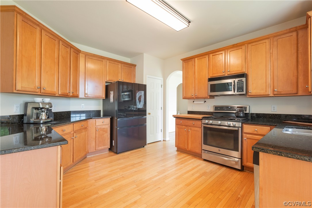 4917 Chappell Ridge Terrace Glen Allen, VA 23059 - Photo 18 of 50 a kitchen with stainless steel appliances granite countertop a stove top oven a refrigerator and a sink with granite countertops