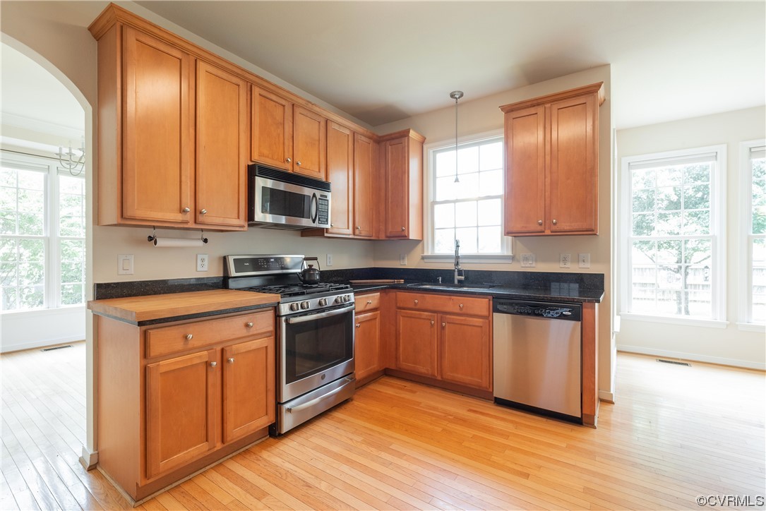 4917 Chappell Ridge Terrace Glen Allen, VA 23059 - Photo 20 of 50 a kitchen with granite countertop wooden floors stainless steel appliances a sink and a window