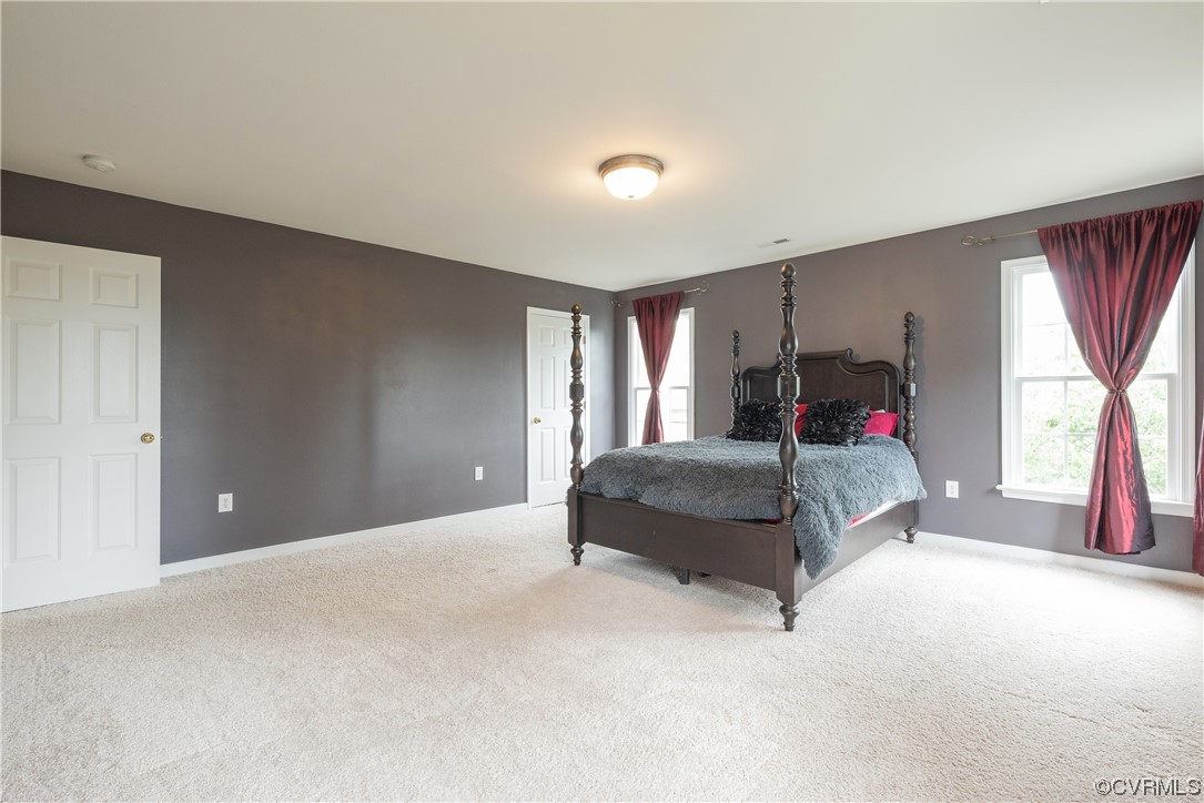 4917 Chappell Ridge Terrace Glen Allen, VA 23059 - Photo 35 of 50 a bedroom with a bed and a large window