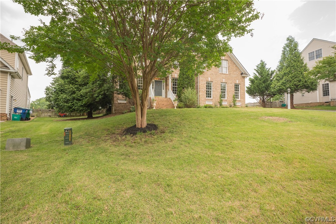 4917 Chappell Ridge Terrace Glen Allen, VA 23059 - Photo 4 of 50 a view of a yard in front of a house with a large tree