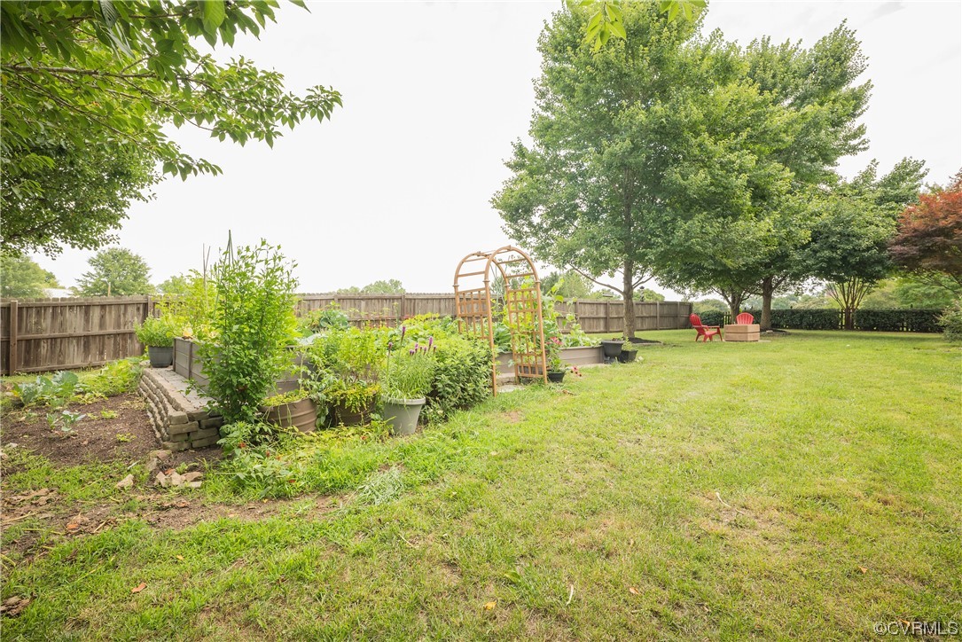 4917 Chappell Ridge Terrace Glen Allen, VA 23059 - Photo 46 of 50 a view of a garden with a building in the background
