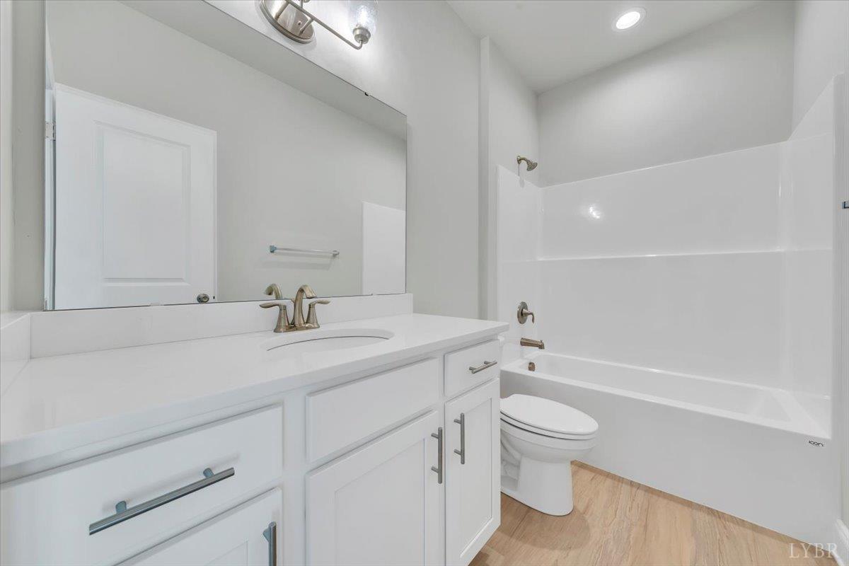 4715 Boonsboro Road Lynchburg, VA 24503 - Photo 18 of 28 a bathroom with a sink a toilet and a large mirror
