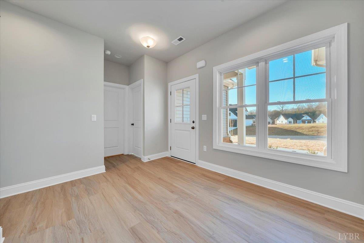 4715 Boonsboro Road Lynchburg, VA 24503 - Photo 3 of 28 an empty room with wooden floor and windows