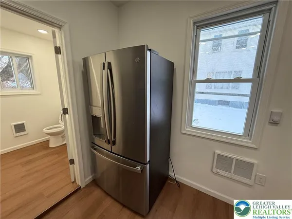 a metallic refrigerator freezer sitting in a kitchen