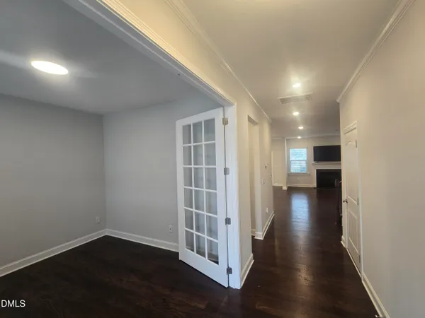 a view of a hallway with wooden floor and a fireplace