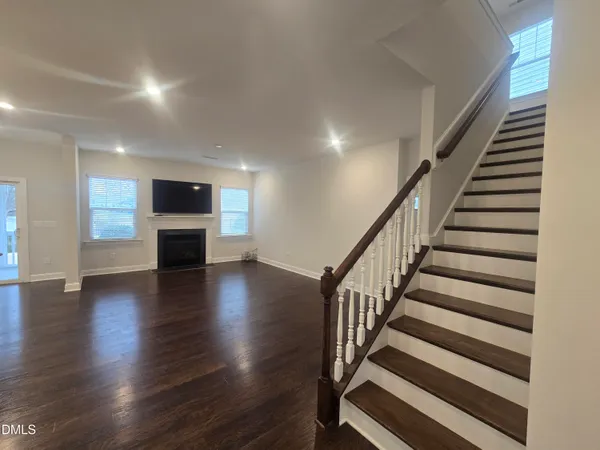 a view of entryway and hall with wooden floor