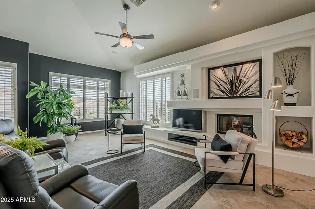 a living room with furniture and a fireplace