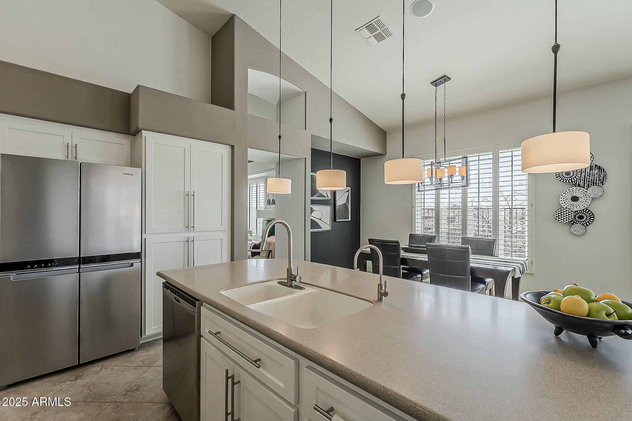 6334 East Viewmont Drive, Unit 29 Mesa, AZ 85215 - Photo 12 of 47 a kitchen with a refrigerator a sink and wooden floor