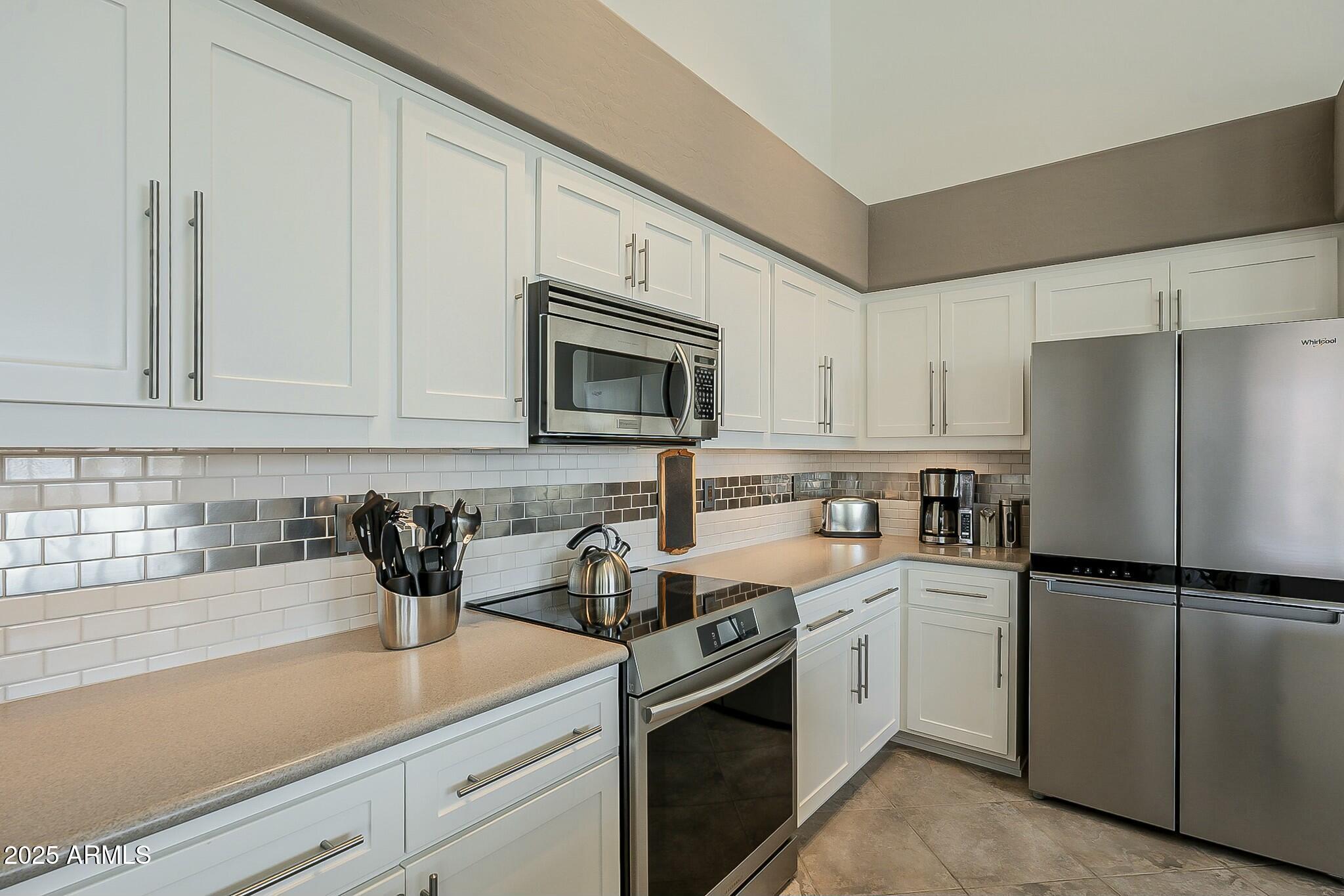 6334 East Viewmont Drive, Unit 29 Mesa, AZ 85215 - Photo 13 of 47 a kitchen with appliances a sink and cabinets