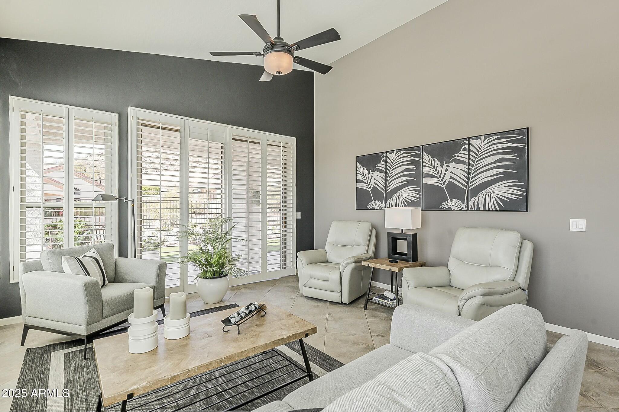 6334 East Viewmont Drive, Unit 29 Mesa, AZ 85215 - Photo 16 of 47 a living room with furniture and a large window with balcony view