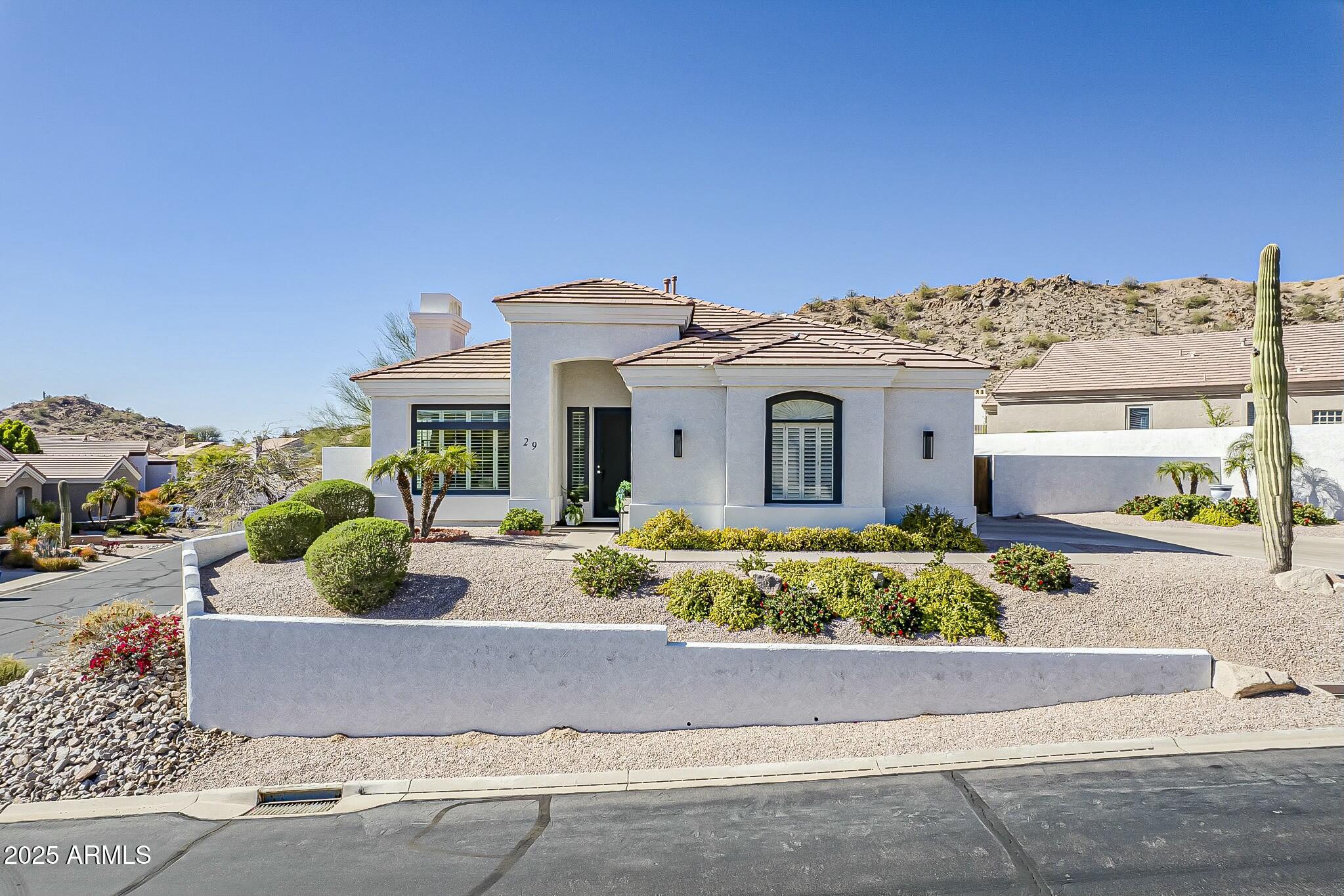 6334 East Viewmont Drive, Unit 29 Mesa, AZ 85215 - Photo 2 of 47 front view of a house with potted plants