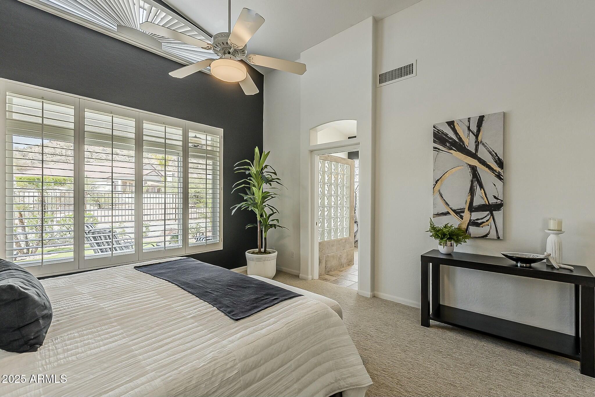 6334 East Viewmont Drive, Unit 29 Mesa, AZ 85215 - Photo 21 of 47 a bedroom with a bed and a large window