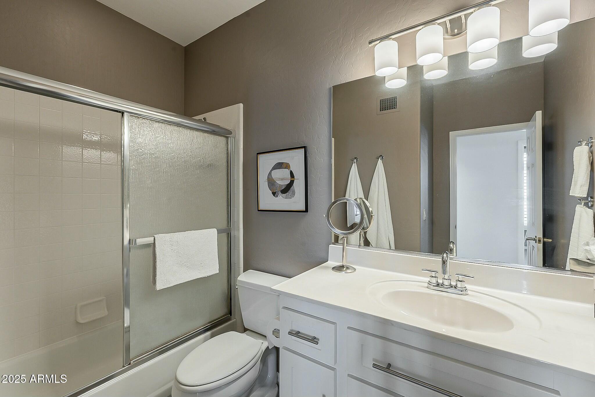 6334 East Viewmont Drive, Unit 29 Mesa, AZ 85215 - Photo 28 of 47 a bathroom with a sink vanity mirror and toilet