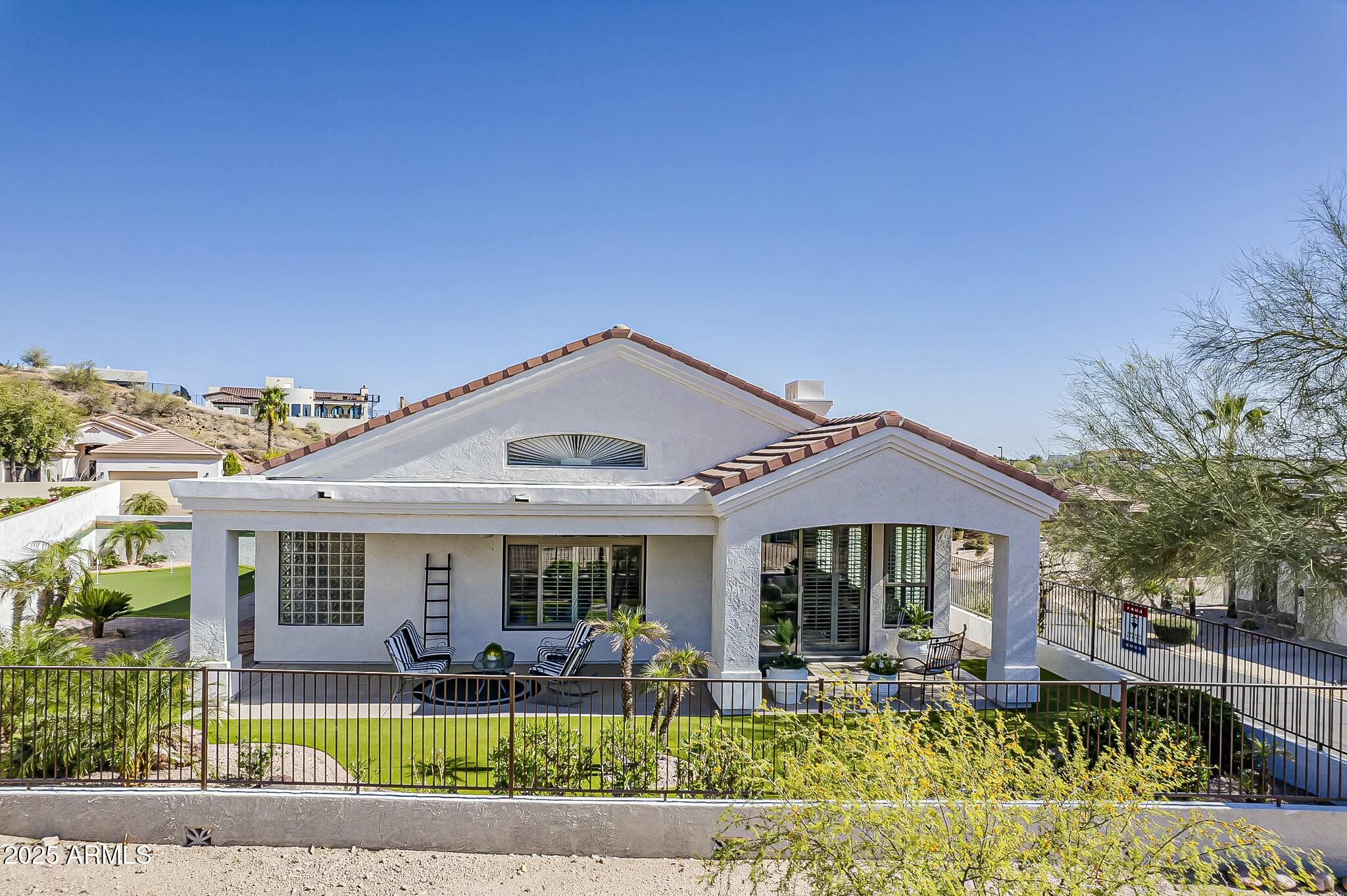 6334 East Viewmont Drive, Unit 29 Mesa, AZ 85215 - Photo 30 of 47 a front view of a house with swimming pool and chairs