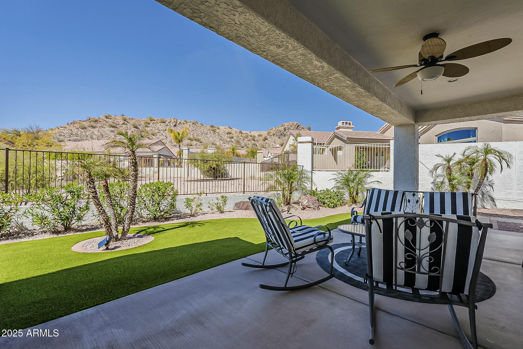 6334 East Viewmont Drive, Unit 29 Mesa, AZ 85215 - Photo 35 of 47 a view of a chairs and table in patio with a fire pit