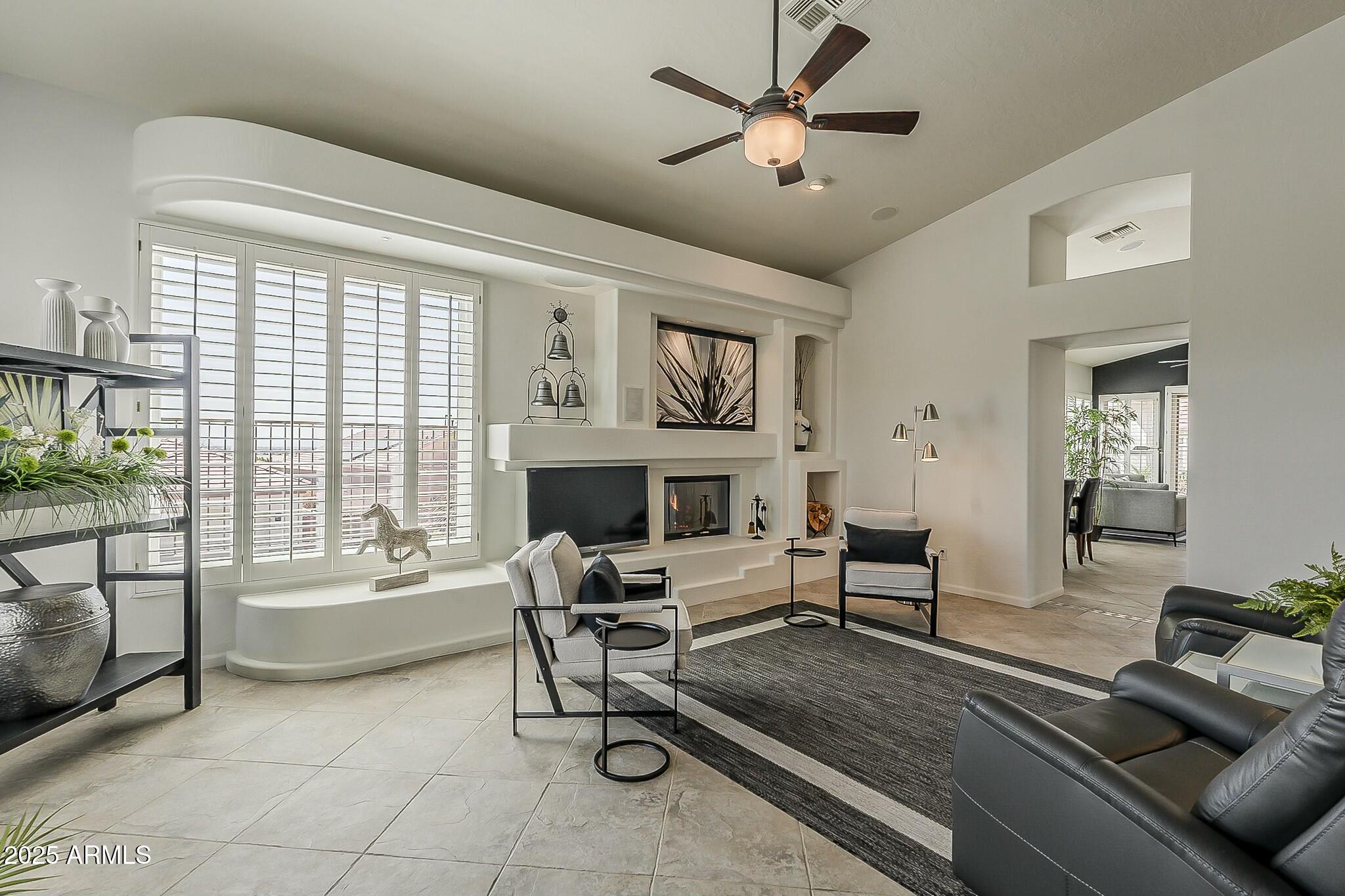6334 East Viewmont Drive, Unit 29 Mesa, AZ 85215 - Photo 5 of 47 a living room with furniture a fireplace and a large window