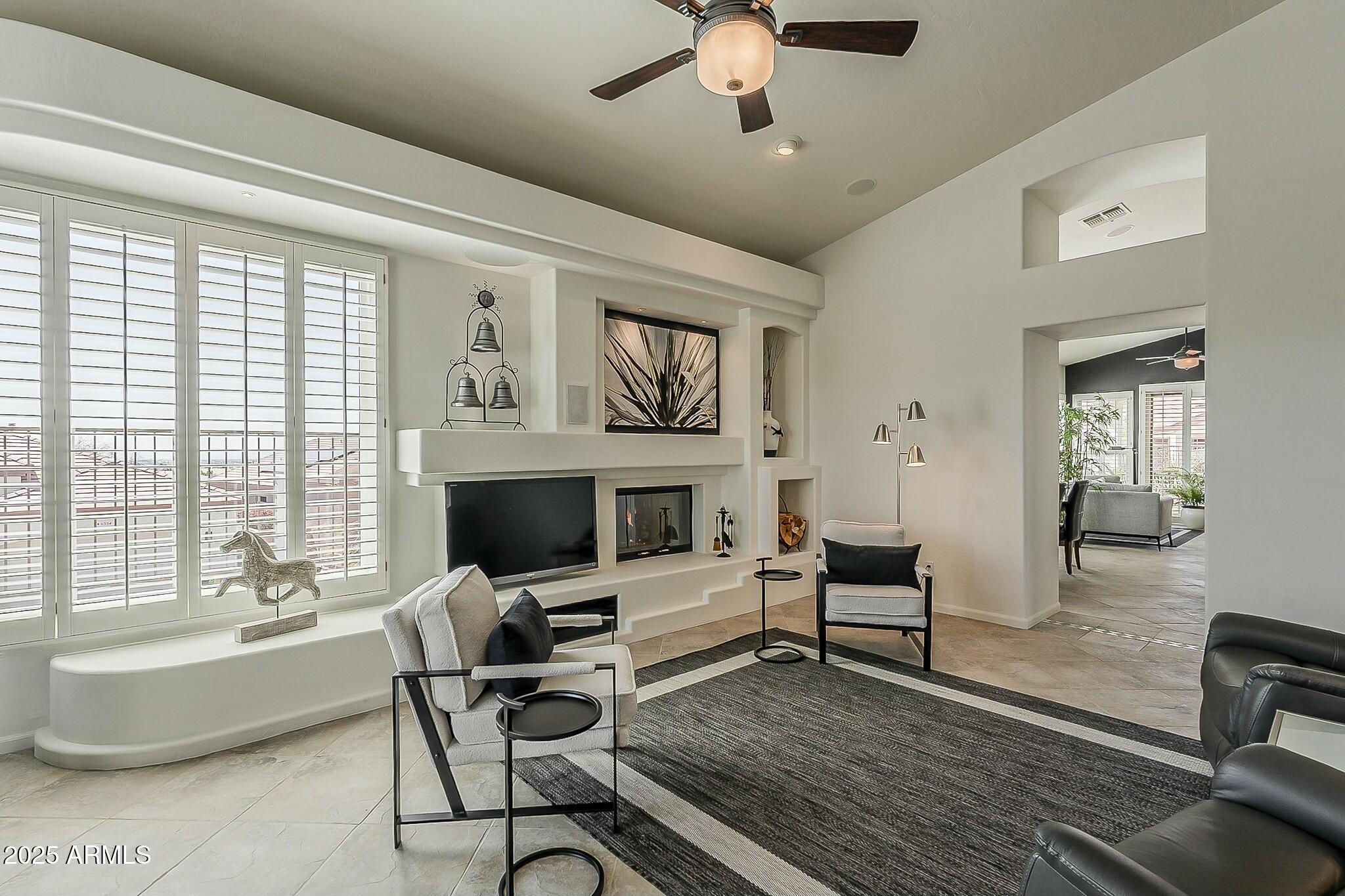 6334 East Viewmont Drive, Unit 29 Mesa, AZ 85215 - Photo 6 of 47 a living room with furniture fireplace and window