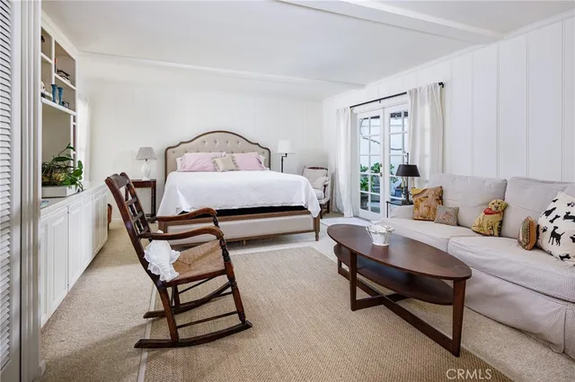 a bedroom with furniture and a window