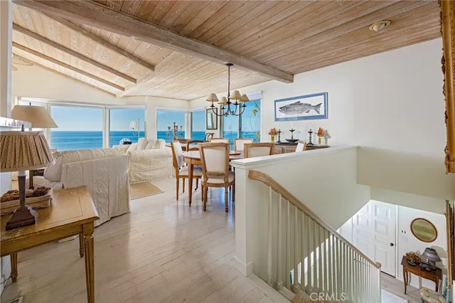 a view of a dining room with furniture and a chandelier