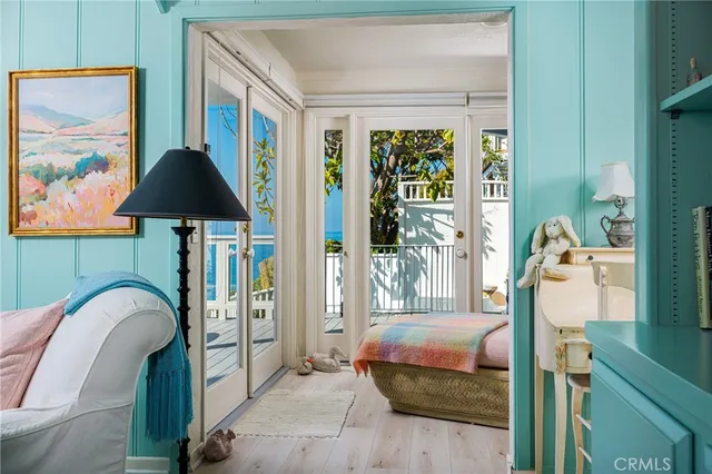 a bedroom with a bed and a painting on the wall