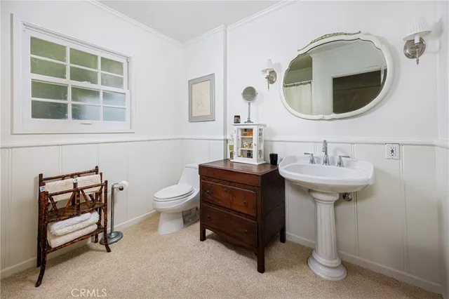 a bathroom with a sink a mirror and a toilet