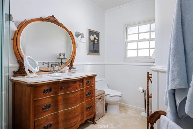 a bathroom with a toilet a sink and a mirror