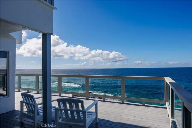 a view of a balcony with chair and wooden floor